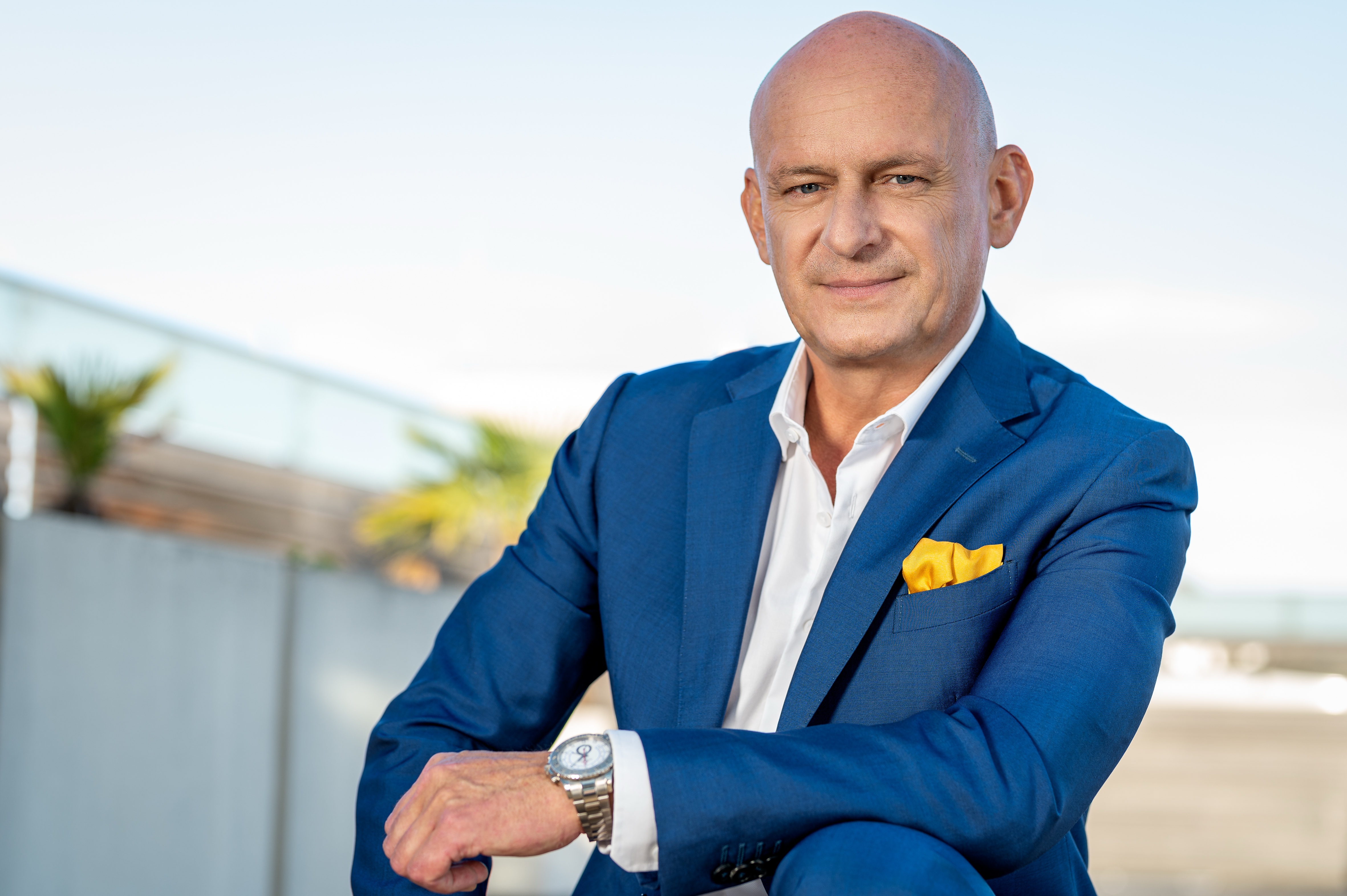 Hubert Freidl – Business Architect, seated with phone, Dubai