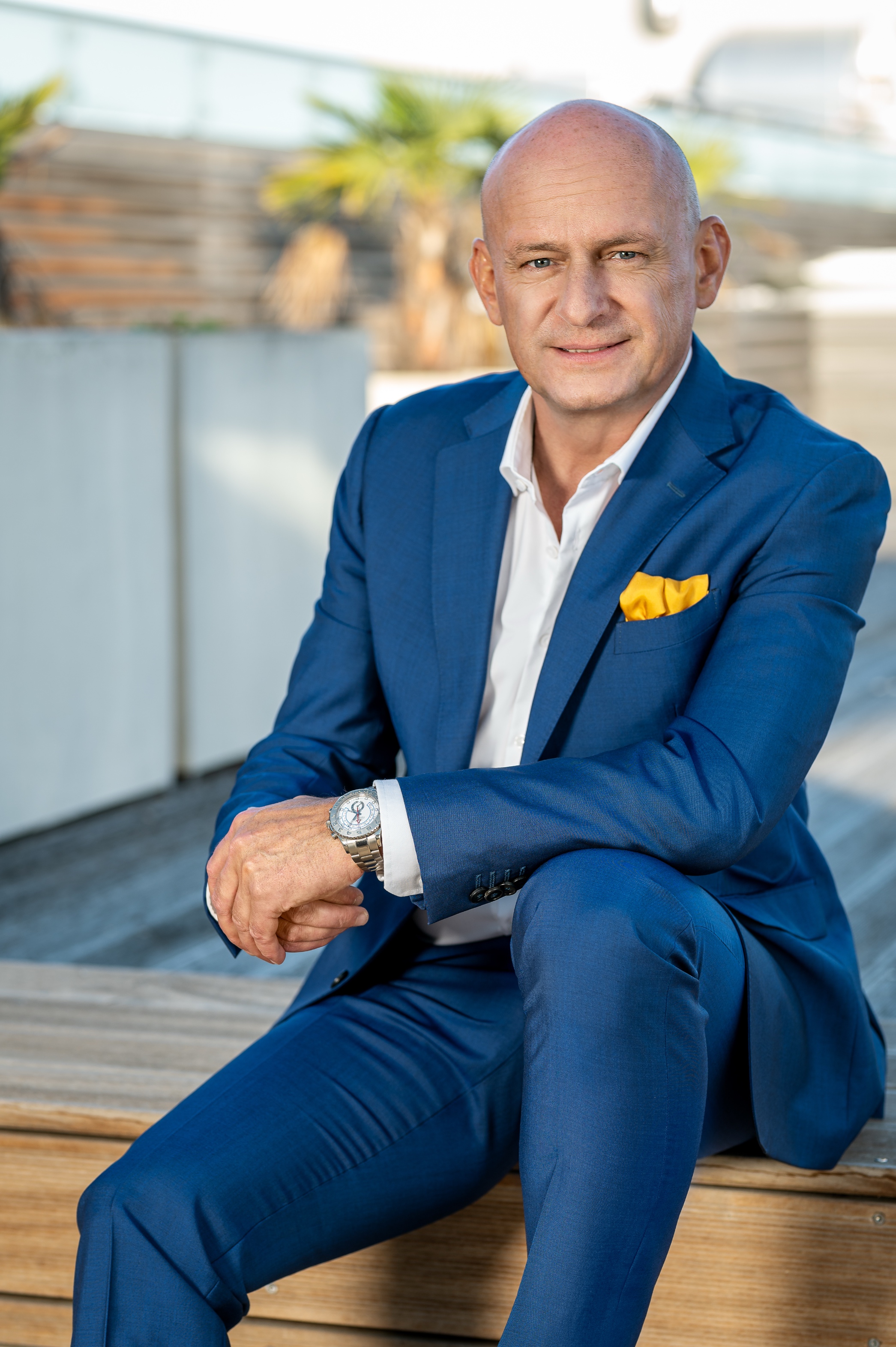 Hubert Freidl – Entrepreneur and Strategic Advisor, seated, blue suit